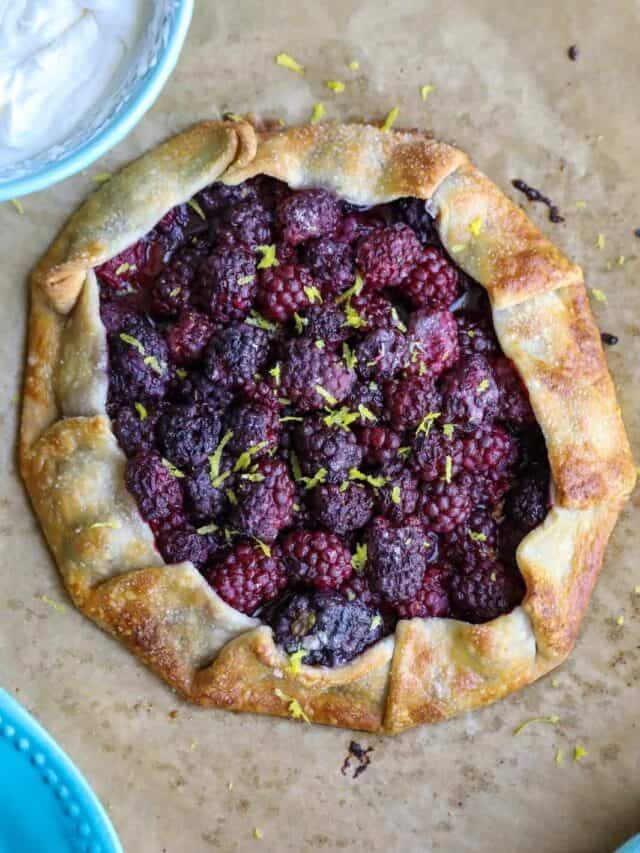 Flat lay shot of a whole Blackberry Galette on a wooden surface