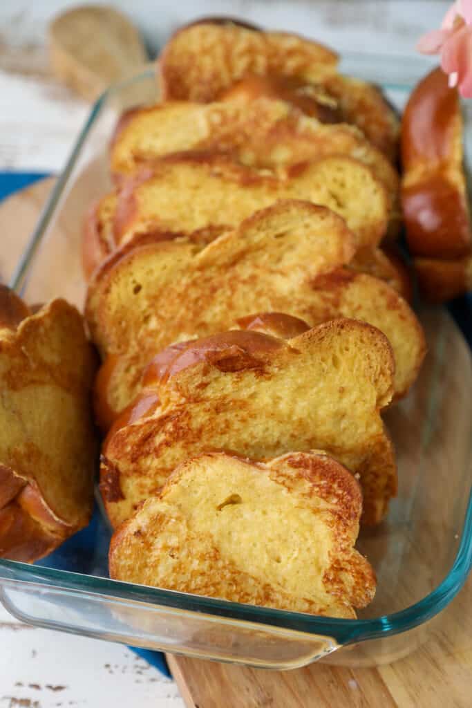 Cooked challah french toast arranged in a casserole dish