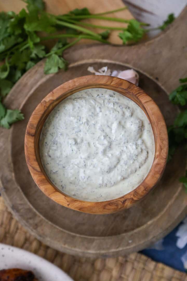 cilantro garlic lime sauce in wooden bowl