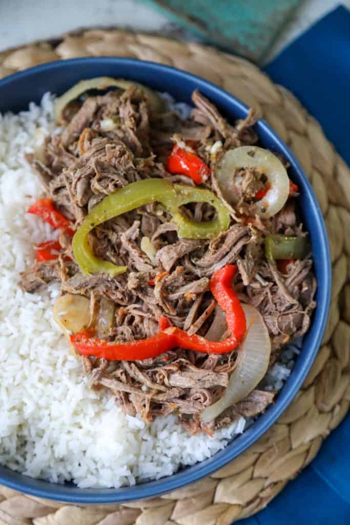Ropa Vieja in a blue dish with white rice
