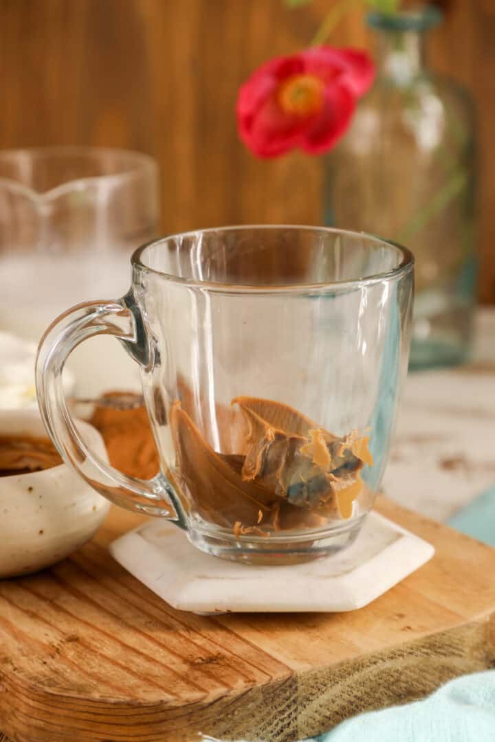 clear mug with cookie butter inside